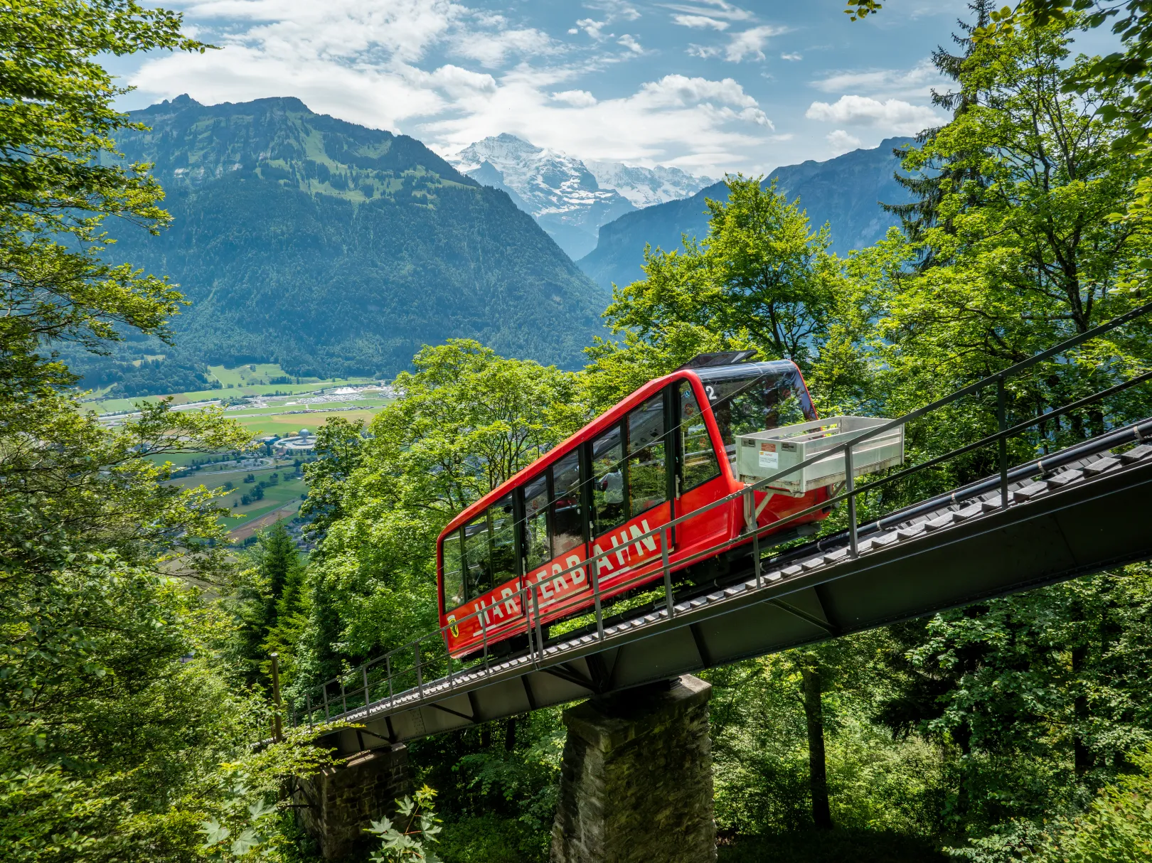 The Harder Kulm railway runs in summer through a wooded hillside above Interlaken.