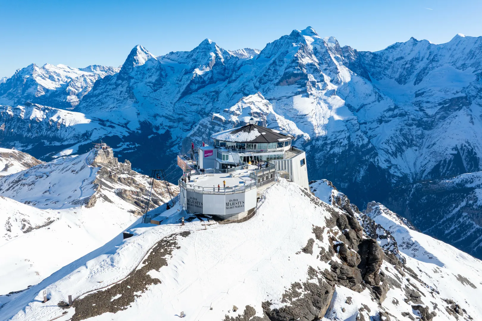 Skyline View Platform on the Schilthorn, with glaciers and snow-covered mountains in the background.